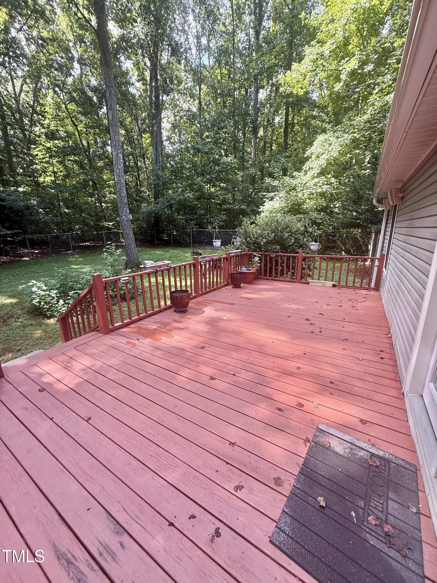 192 Misty Hollow Road Timberlake, NC 27583 - Photo 32 of 43 a patio with wooden floor and lake view