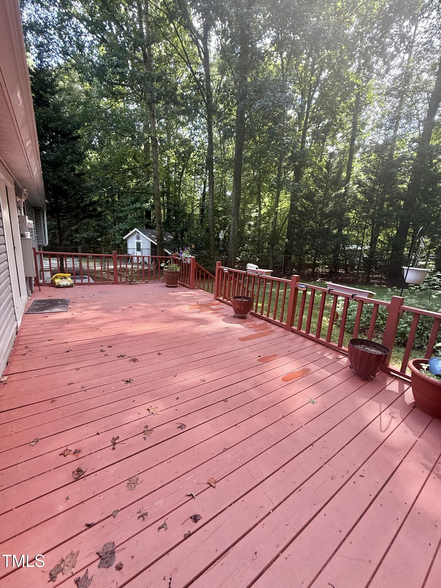 192 Misty Hollow Road Timberlake, NC 27583 - Photo 33 of 43 a patio with wooden floor and trees
