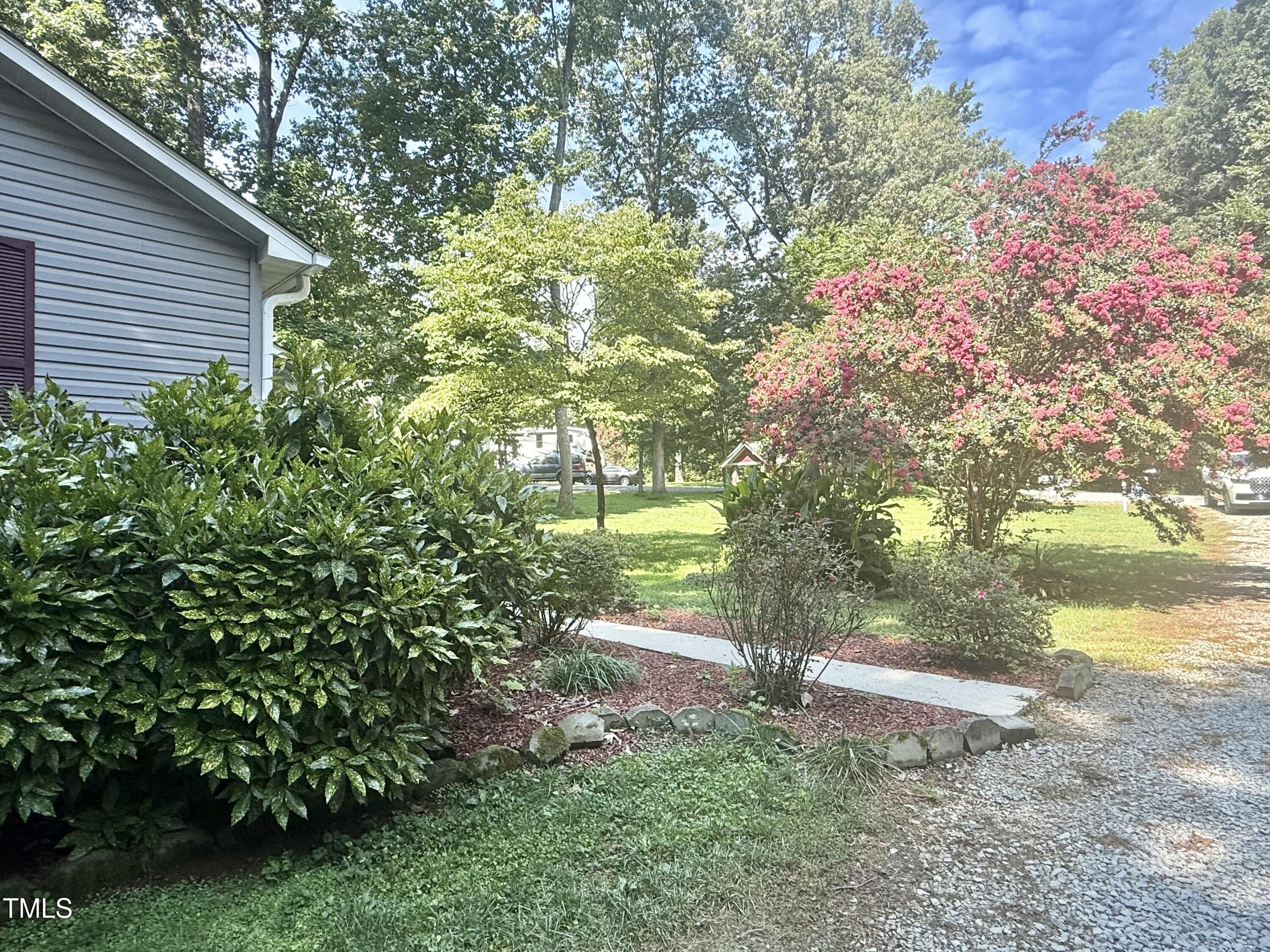 192 Misty Hollow Road Timberlake, NC 27583 - Photo 39 of 43 a backyard of a house with lots of green space