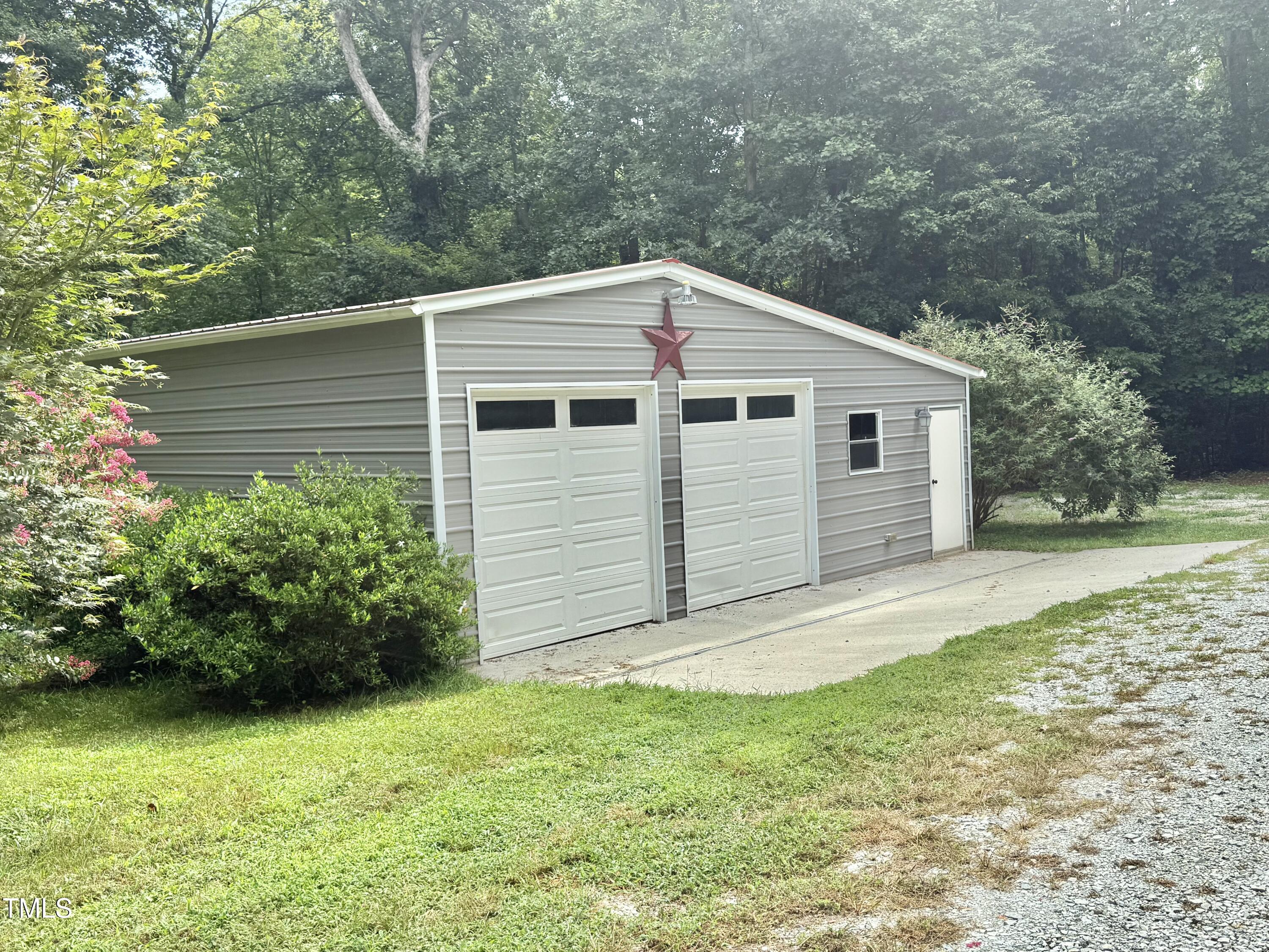 192 Misty Hollow Road Timberlake, NC 27583 - Photo 42 of 43 a front view of a house with a garden