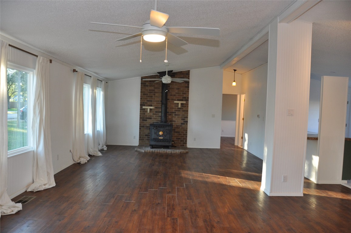 367 Mesquite Street Bertram, TX 78605 - Photo 15 of 23 an empty room with wooden floor and windows