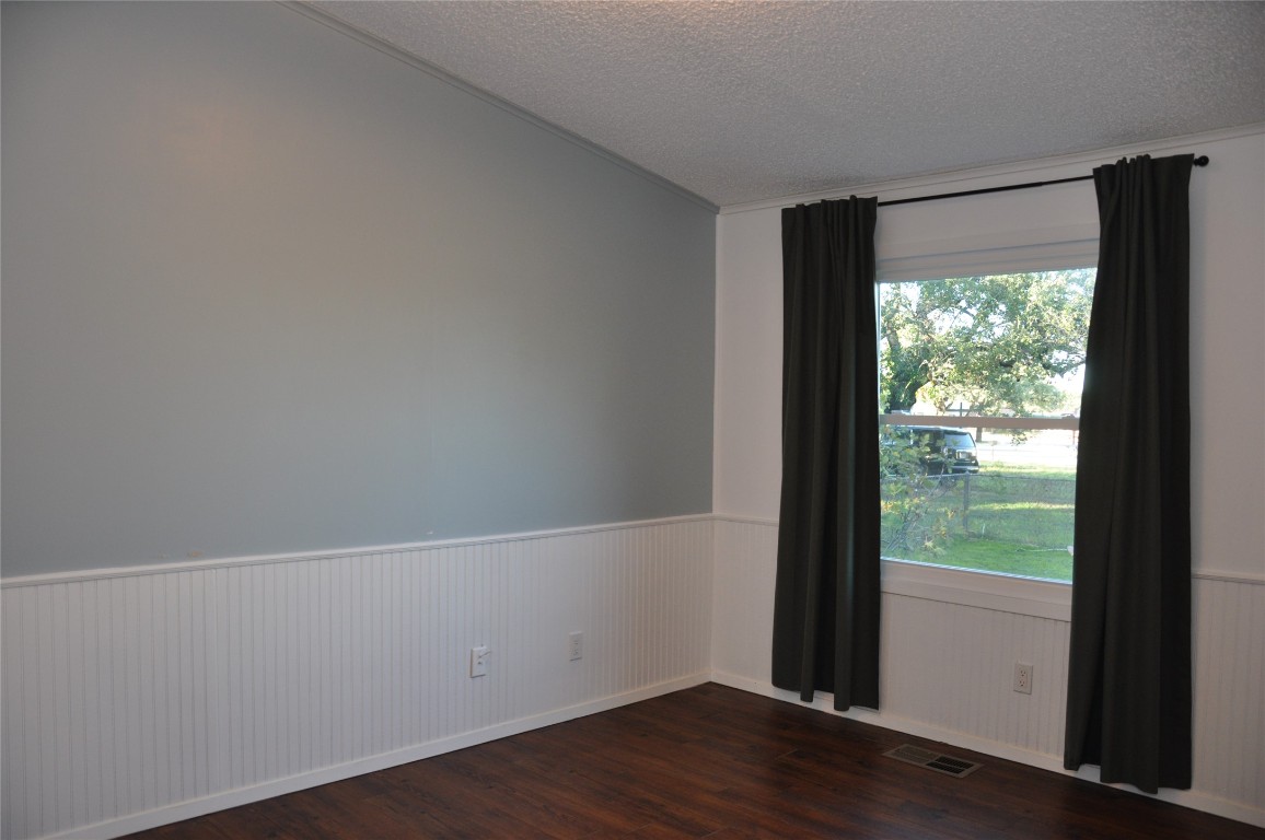 367 Mesquite Street Bertram, TX 78605 - Photo 19 of 23 a view of an empty room with wooden floor and a window