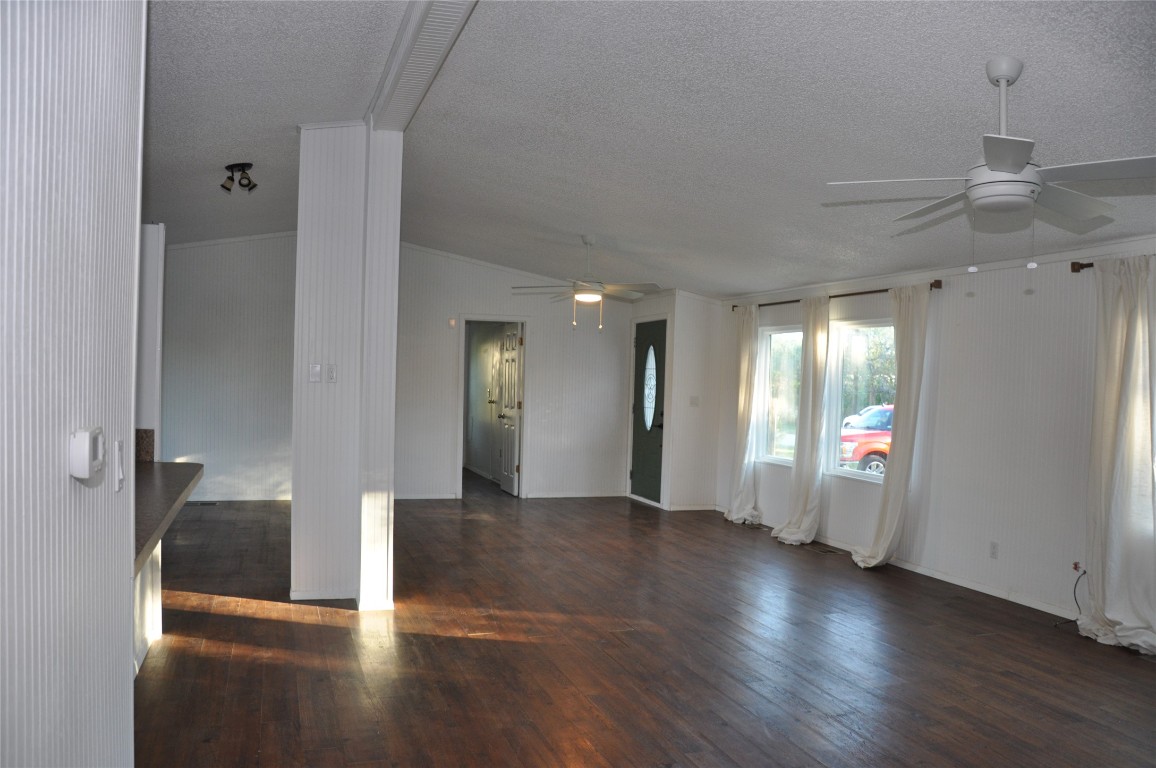 367 Mesquite Street Bertram, TX 78605 - Photo 20 of 23 a view of a hallway with wooden floor and a bathroom