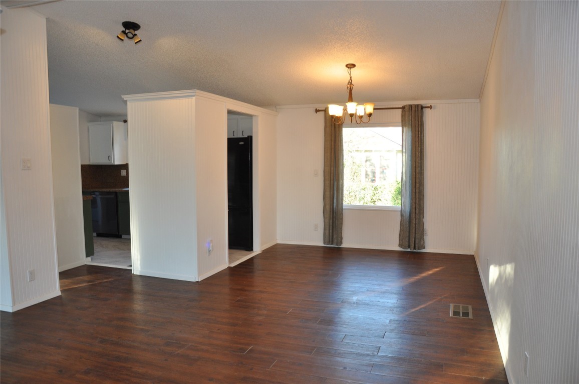 367 Mesquite Street Bertram, TX 78605 - Photo 4 of 23 a view of an empty room with window and wooden floor