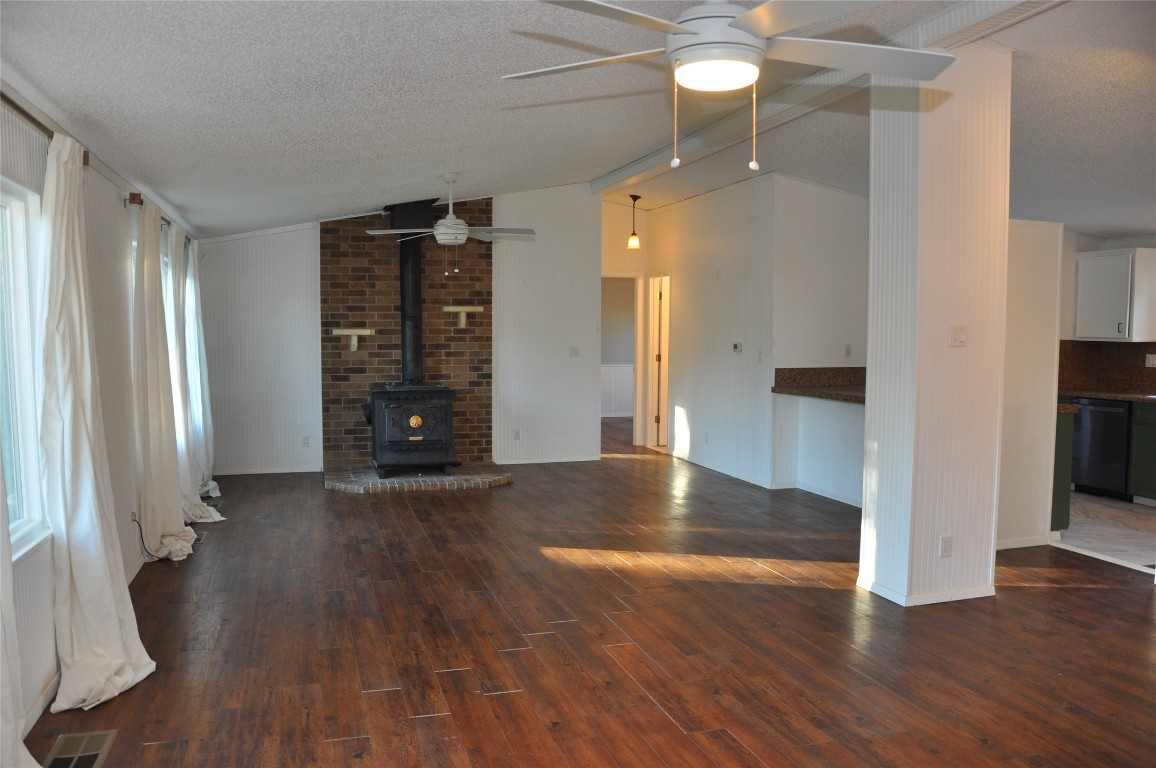 367 Mesquite Street Bertram, TX 78605 - Photo 5 of 23 an empty room with wooden floor and windows