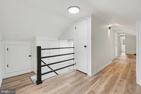 a view of a room with wooden floor and white walls