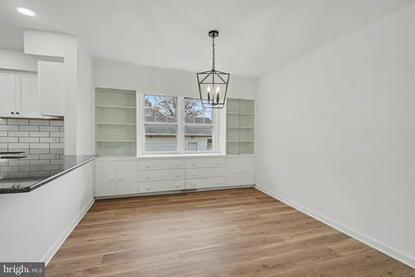a view of wooden floor and windows in a room