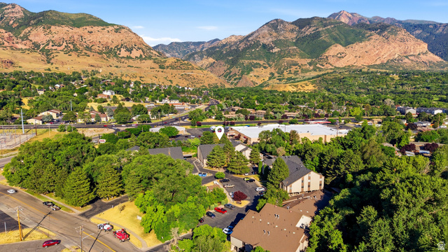 1175 Canyon Road, Unit 86 Ogden, UT 84404 - Photo 27 of 29 Mountainous backdrop with extensive tree coverage and visible structures, featuring multiple paved parking areas and a prominent road system