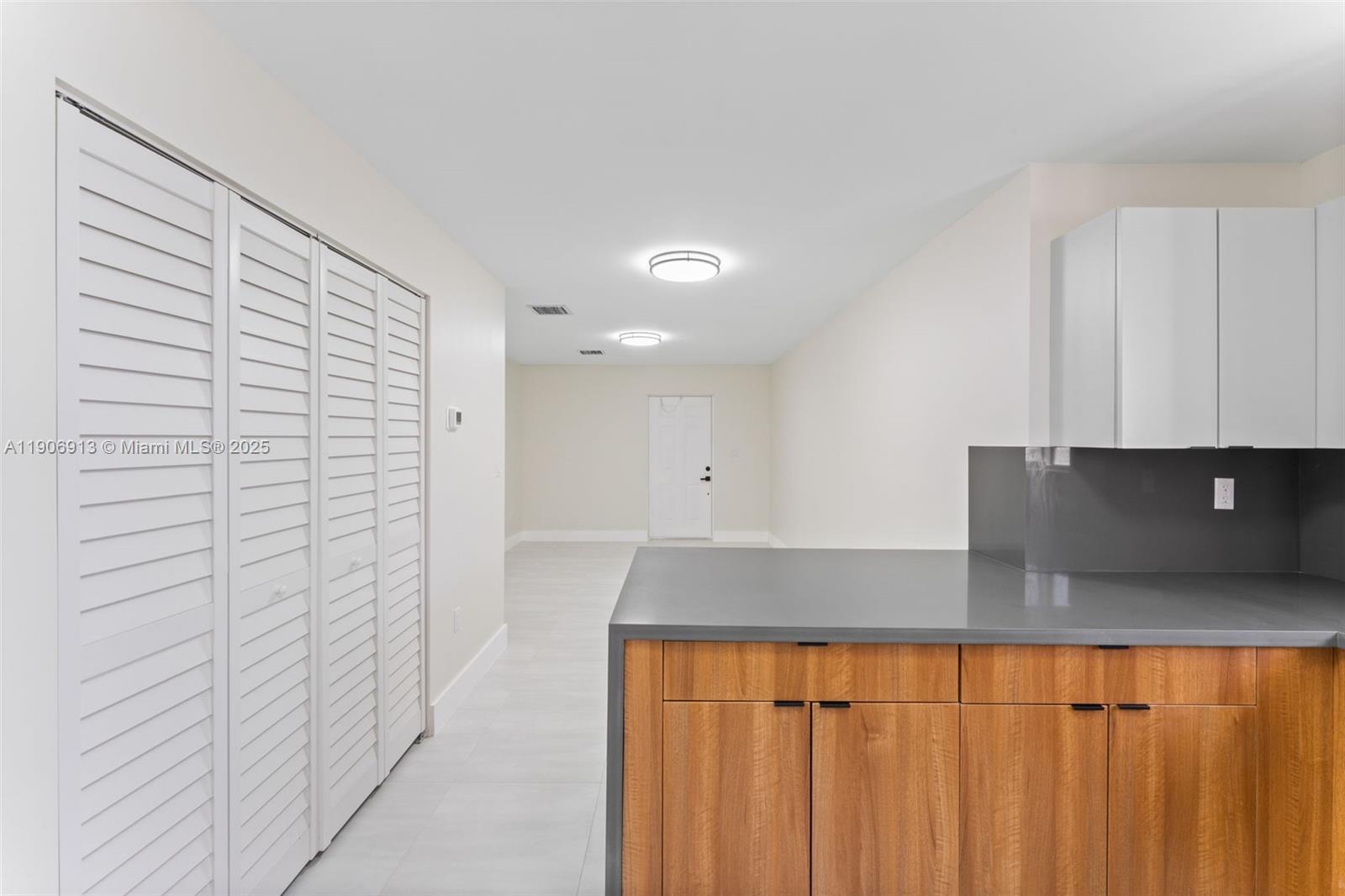 1171 Northwest 66th Street Miami, FL 33150 - Photo 11 of 34 a kitchen with a refrigerator and cabinets
