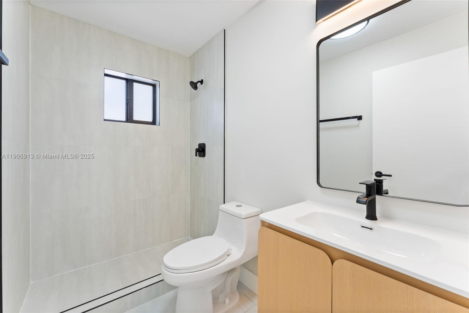 1171 Northwest 66th Street Miami, FL 33150 - Photo 12 of 34 a bathroom with a sink a toilet and shower