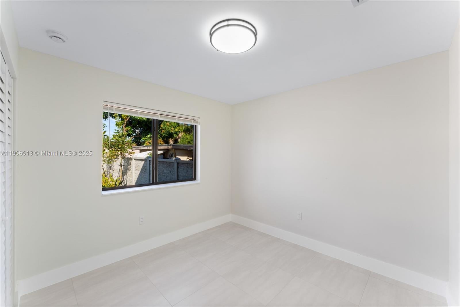 1171 Northwest 66th Street Miami, FL 33150 - Photo 13 of 34 an empty room with windows