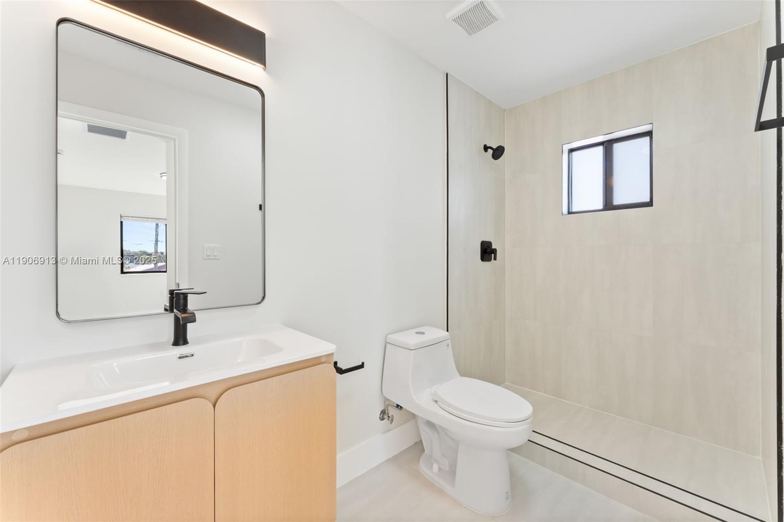 1171 Northwest 66th Street Miami, FL 33150 - Photo 22 of 34 a bathroom with a sink a toilet and shower