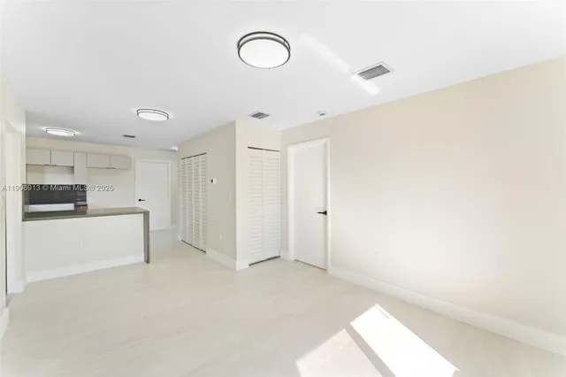 a kitchen with stainless steel appliances granite countertop a sink and dishwasher a refrigerator with wooden cabinets