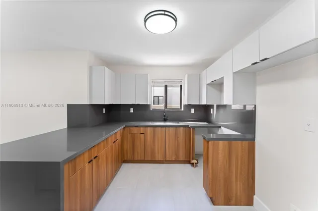 a view of a kitchen with a sink cabinets and a refrigerator