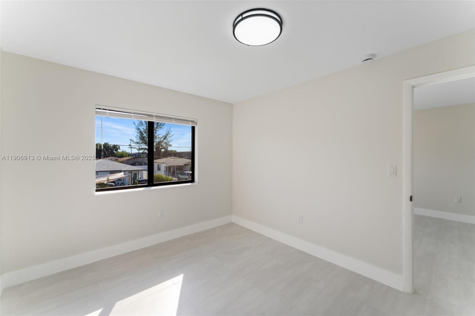 1171 Northwest 66th Street Miami, FL 33150 - Photo 30 of 34 an empty room with windows