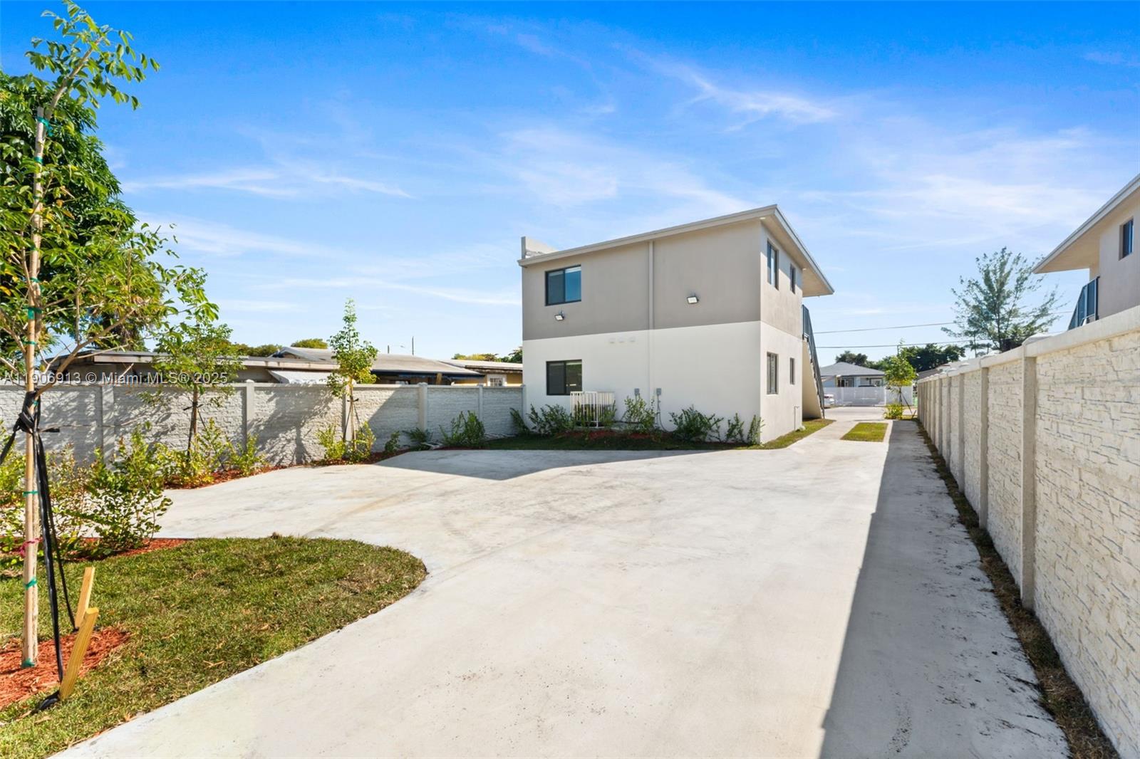 1171 Northwest 66th Street Miami, FL 33150 - Photo 33 of 34 a front view of a house with a yard