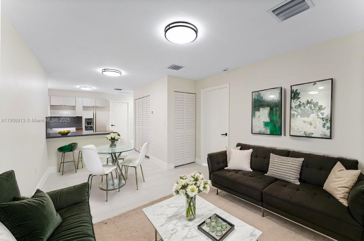 1171 Northwest 66th Street Miami, FL 33150 - Photo 7 of 34 a living room with furniture and kitchen view