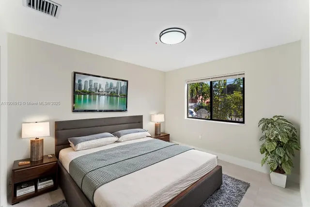 a bathroom with a toilet a sink a mirror a vanity and shower