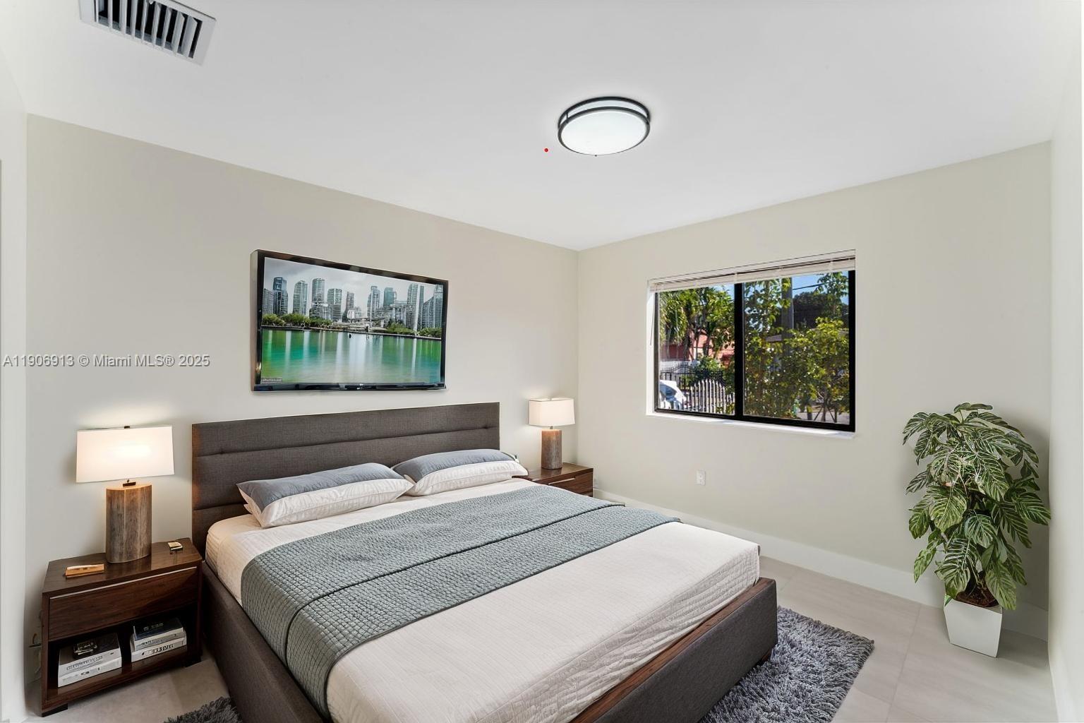 1171 Northwest 66th Street Miami, FL 33150 - Photo 8 of 34 a bedroom with a bed and a window