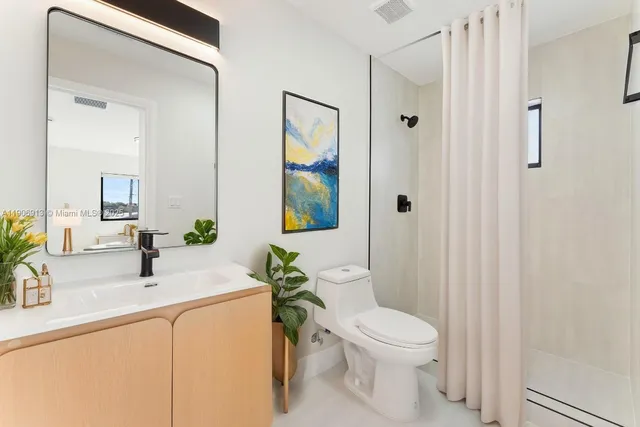 a bedroom with a bed and painting on the wall