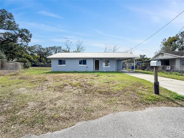 a front view of a house with a garden and yard