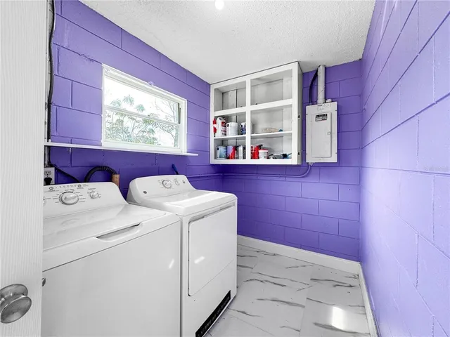 a kitchen with stainless steel appliances granite countertop a refrigerator a stove and a sink