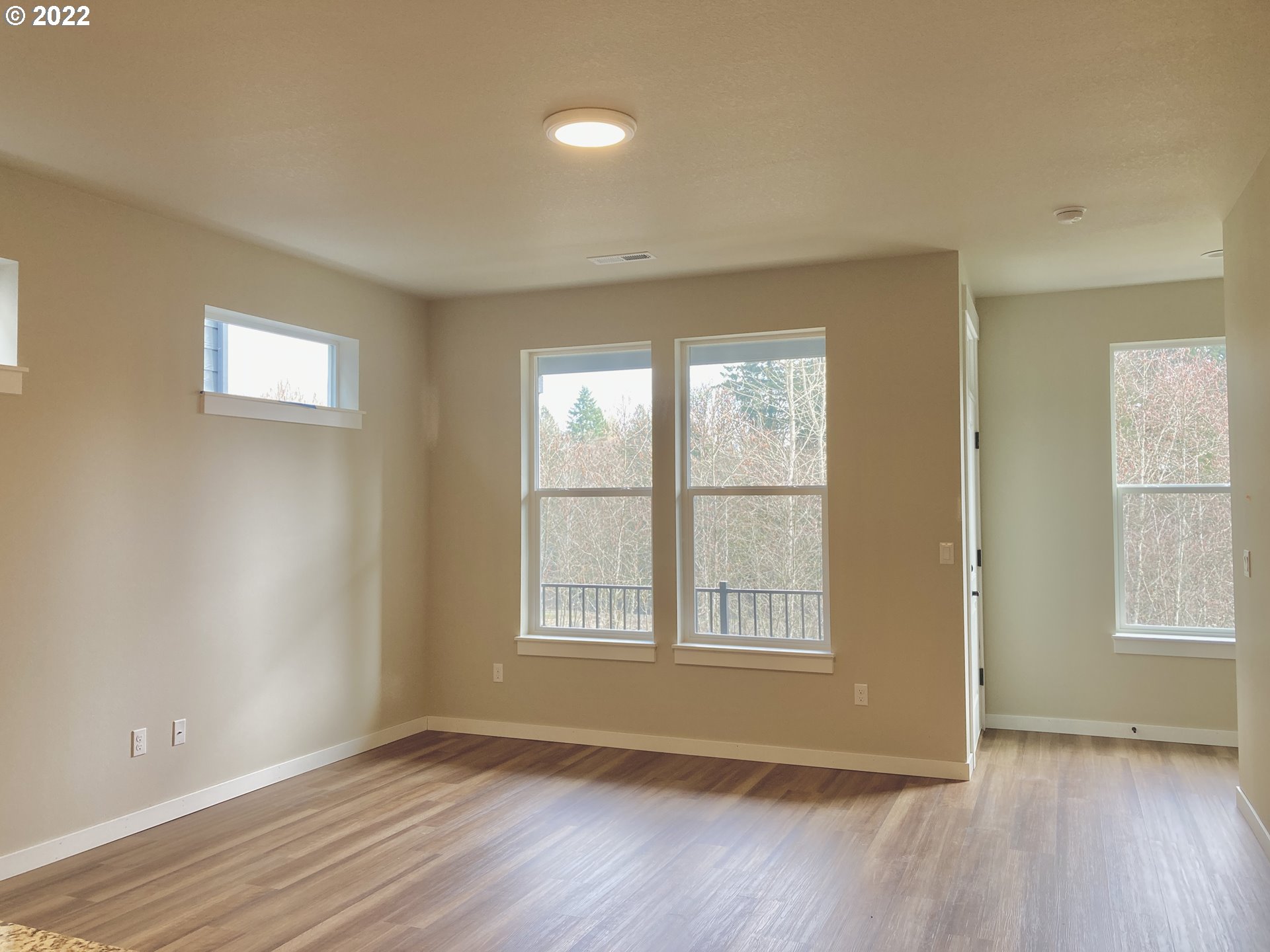 7281 South 13th Street Ridgefield, WA 98642 - Photo 3 of 13 an empty room with wooden floor and windows