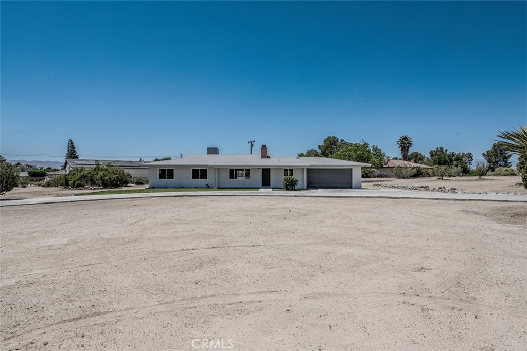 19117 Tecumseh Road Apple Valley, CA 92307 - Photo 1 of 1 a view of a big room with a road