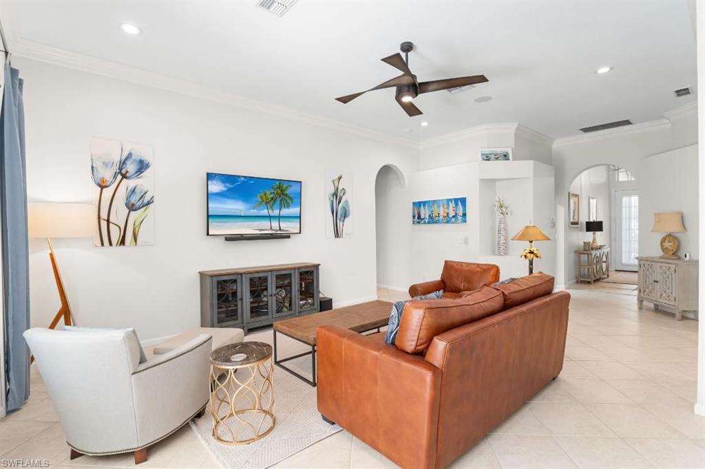 20117 Seadale Court Estero, FL 33928 - Photo 7 of 34 Recessed lighting with a ceiling fan, crown molding, arched doorways, tile flooring, and a built-in media console