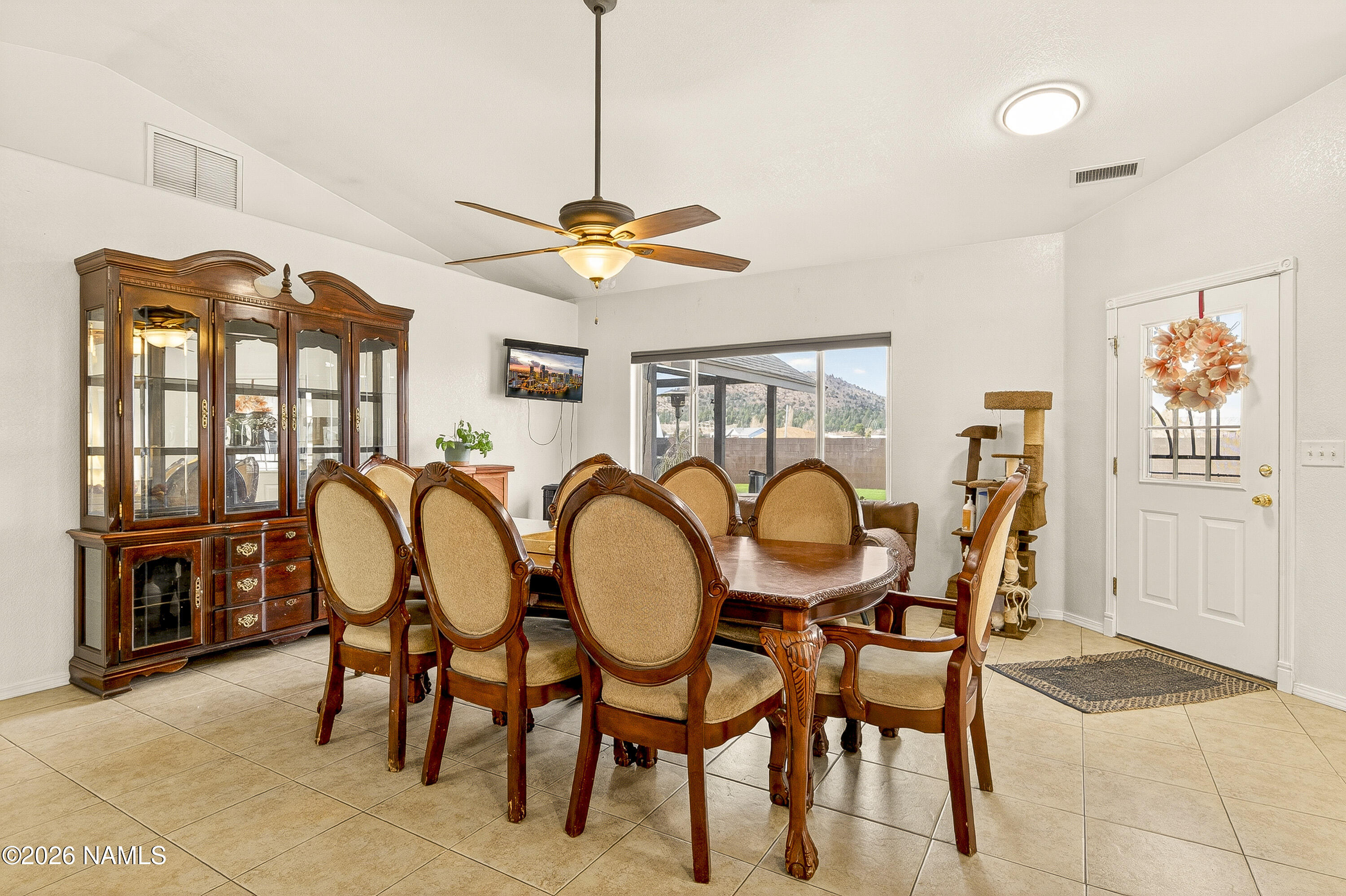 7725 Alma Road Flagstaff, AZ 86004 - Photo 13 of 38 a dining room with furniture a chandelier and window