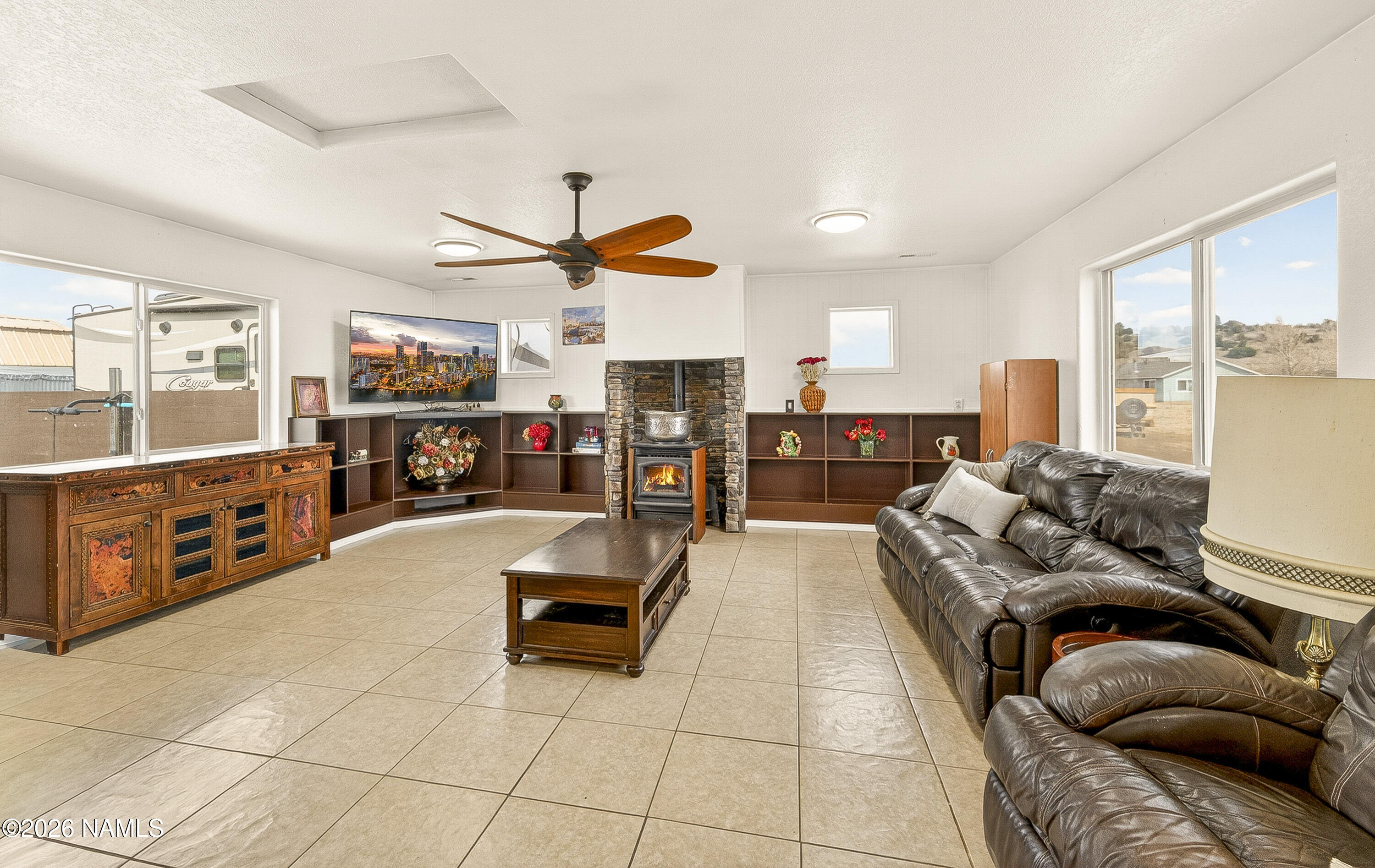 7725 Alma Road Flagstaff, AZ 86004 - Photo 16 of 38 a living room with furniture and a flat screen tv