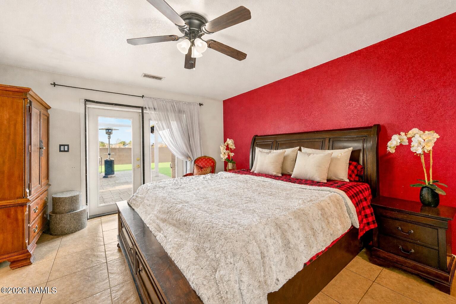 7725 Alma Road Flagstaff, AZ 86004 - Photo 17 of 38 a bedroom with a bed and a chandelier