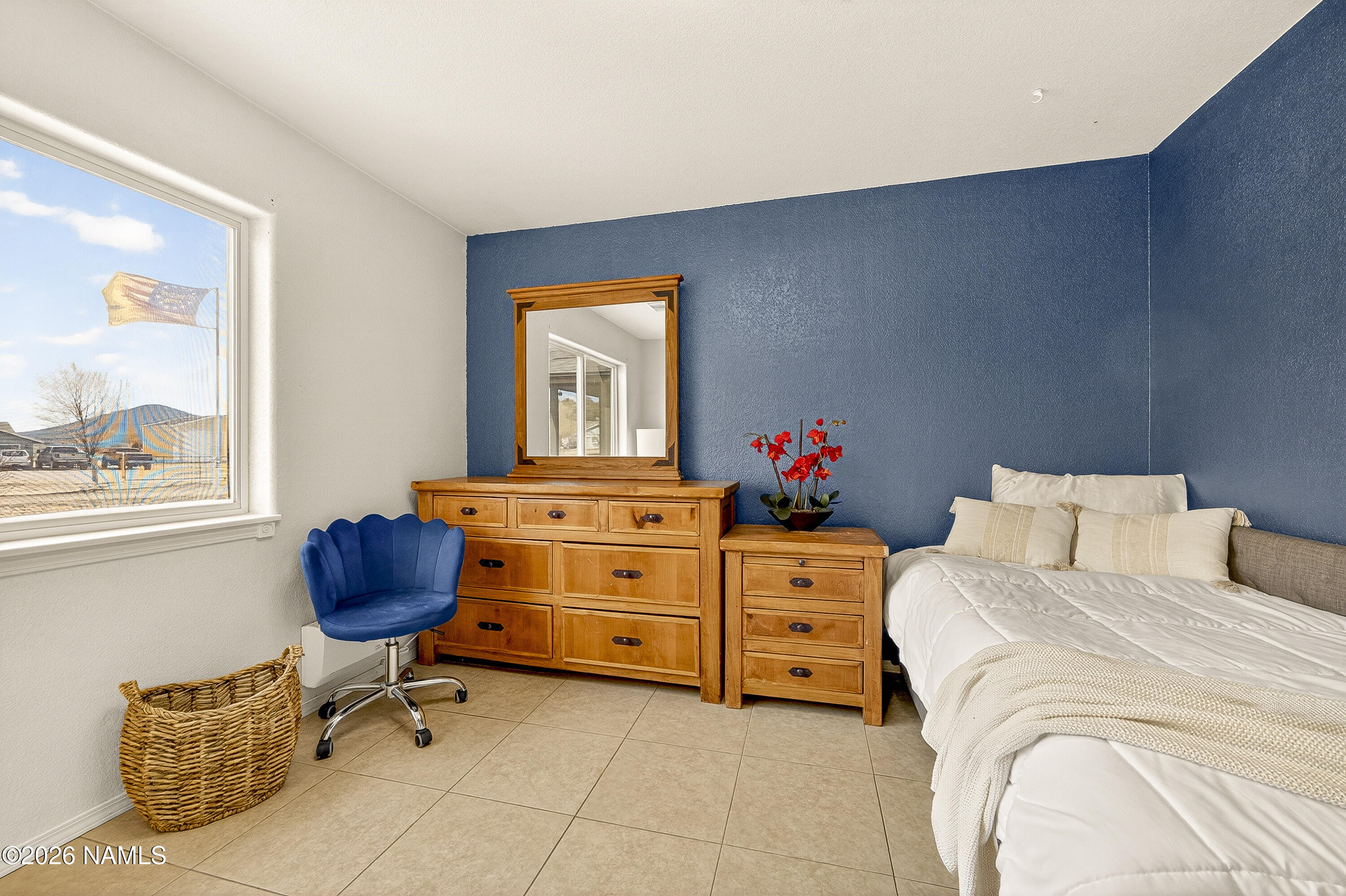 7725 Alma Road Flagstaff, AZ 86004 - Photo 22 of 38 a bedroom with a bed and window
