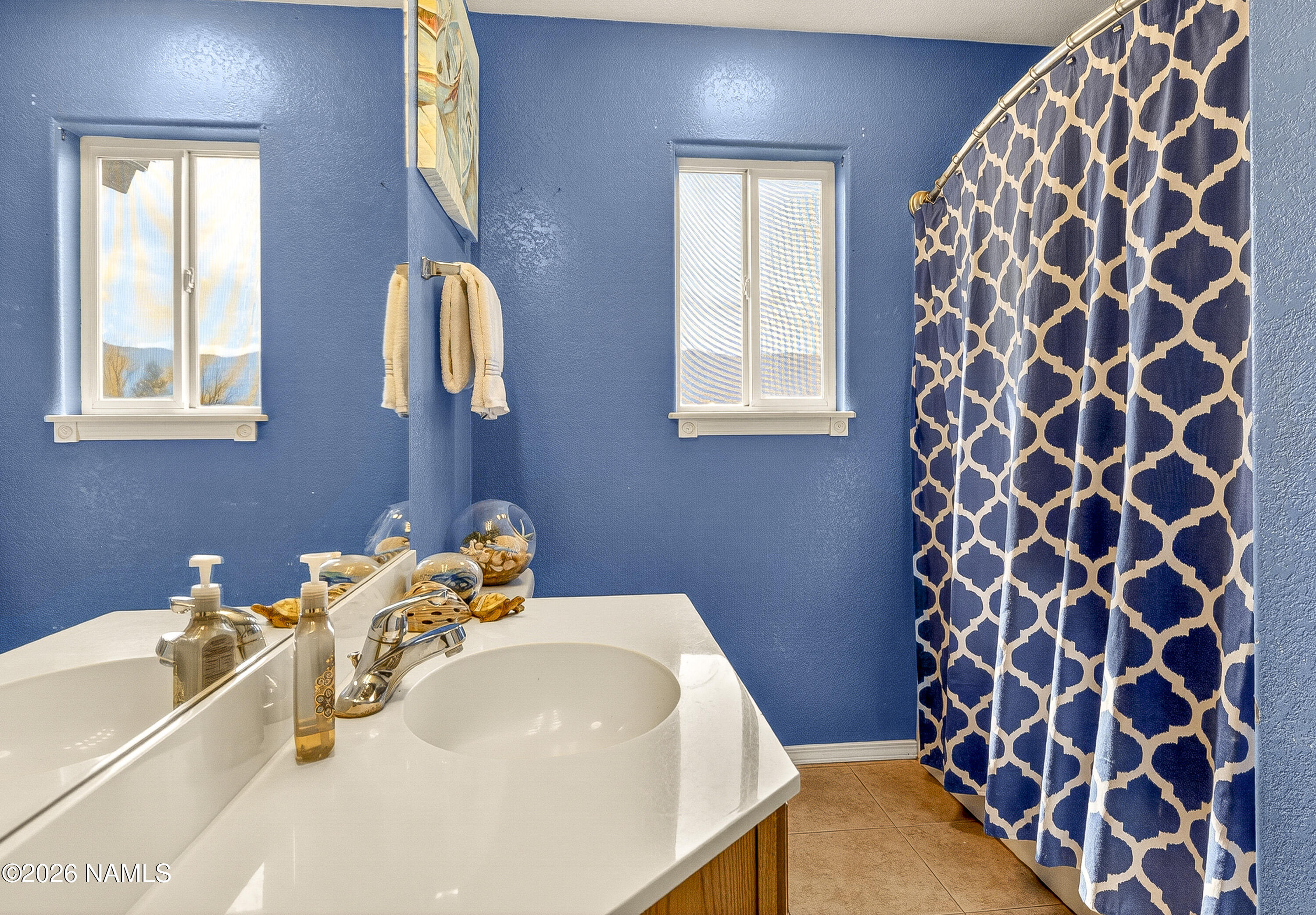 7725 Alma Road Flagstaff, AZ 86004 - Photo 24 of 38 a bathroom with a sink toilet and mirror
