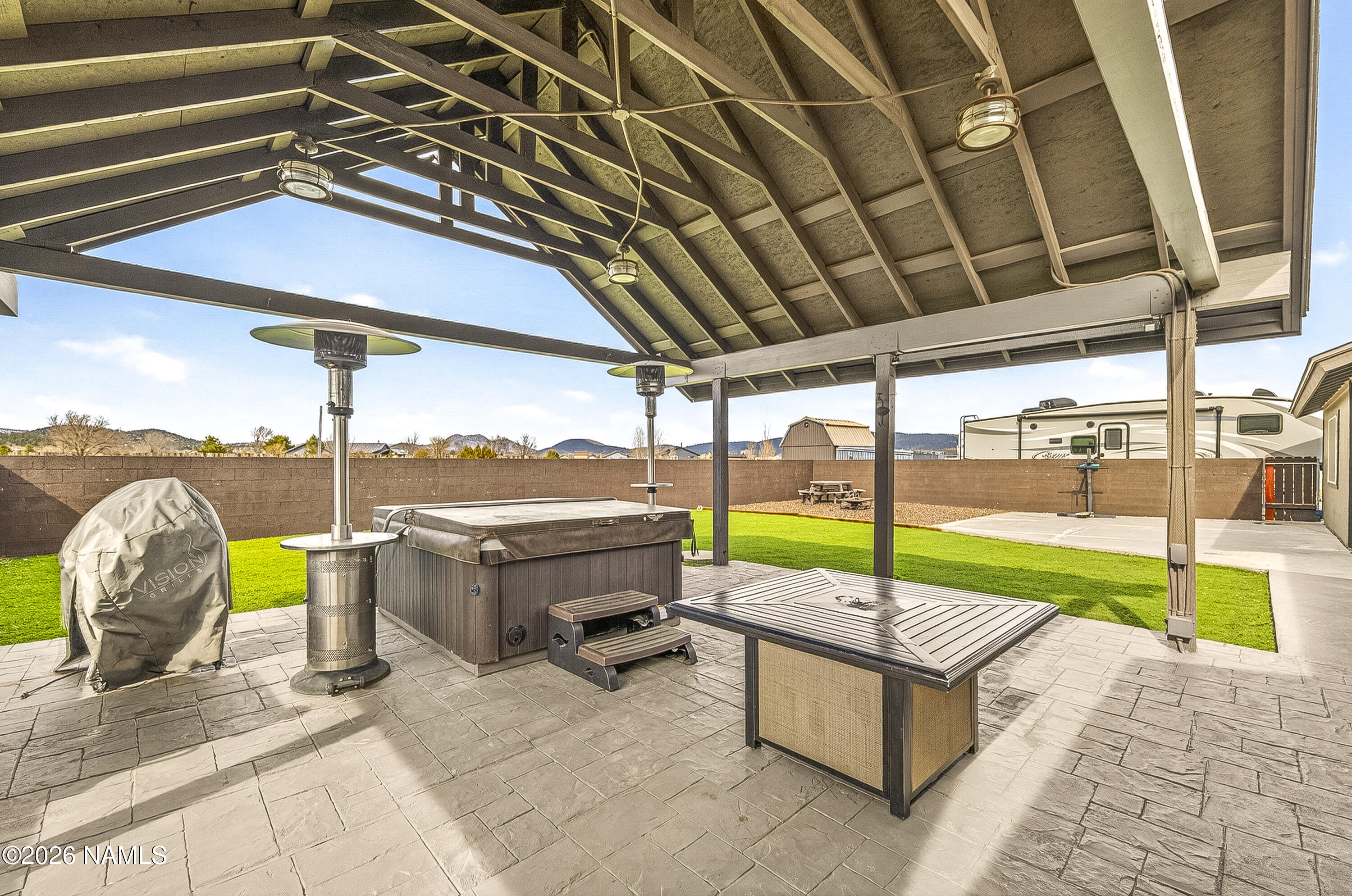 7725 Alma Road Flagstaff, AZ 86004 - Photo 27 of 38 a view of a swimming pool with a patio and a backyard