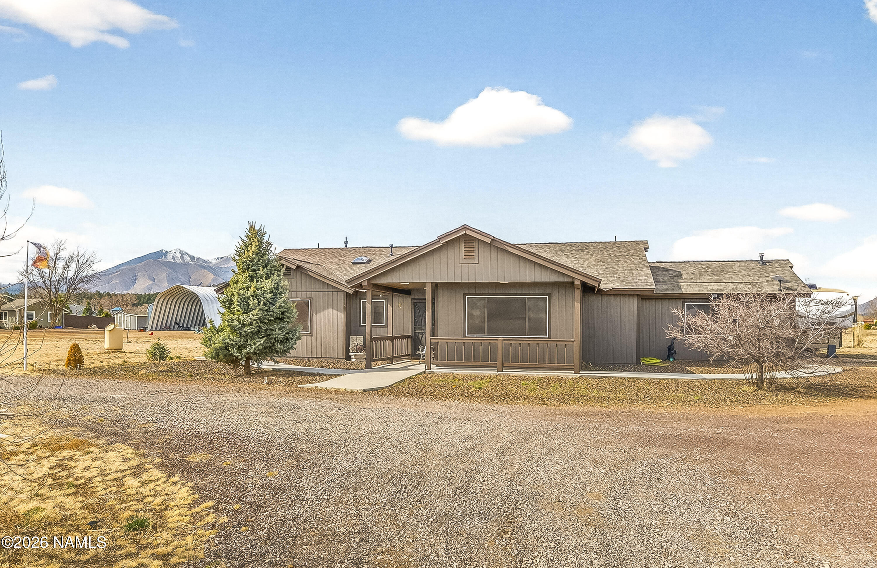 7725 Alma Road Flagstaff, AZ 86004 - Photo 4 of 38 a front view of a house with a yard