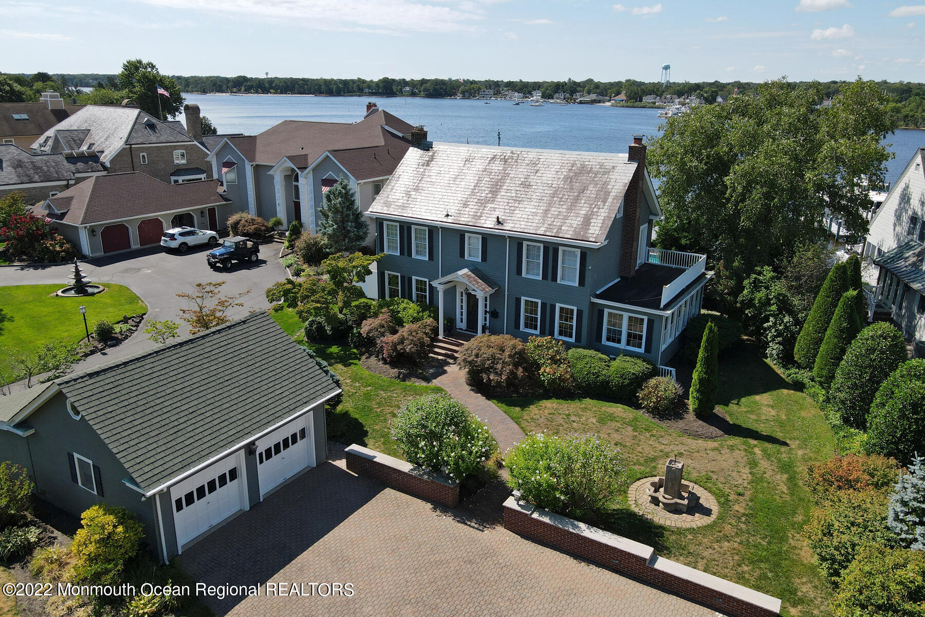 an aerial view of a house with yard and patio