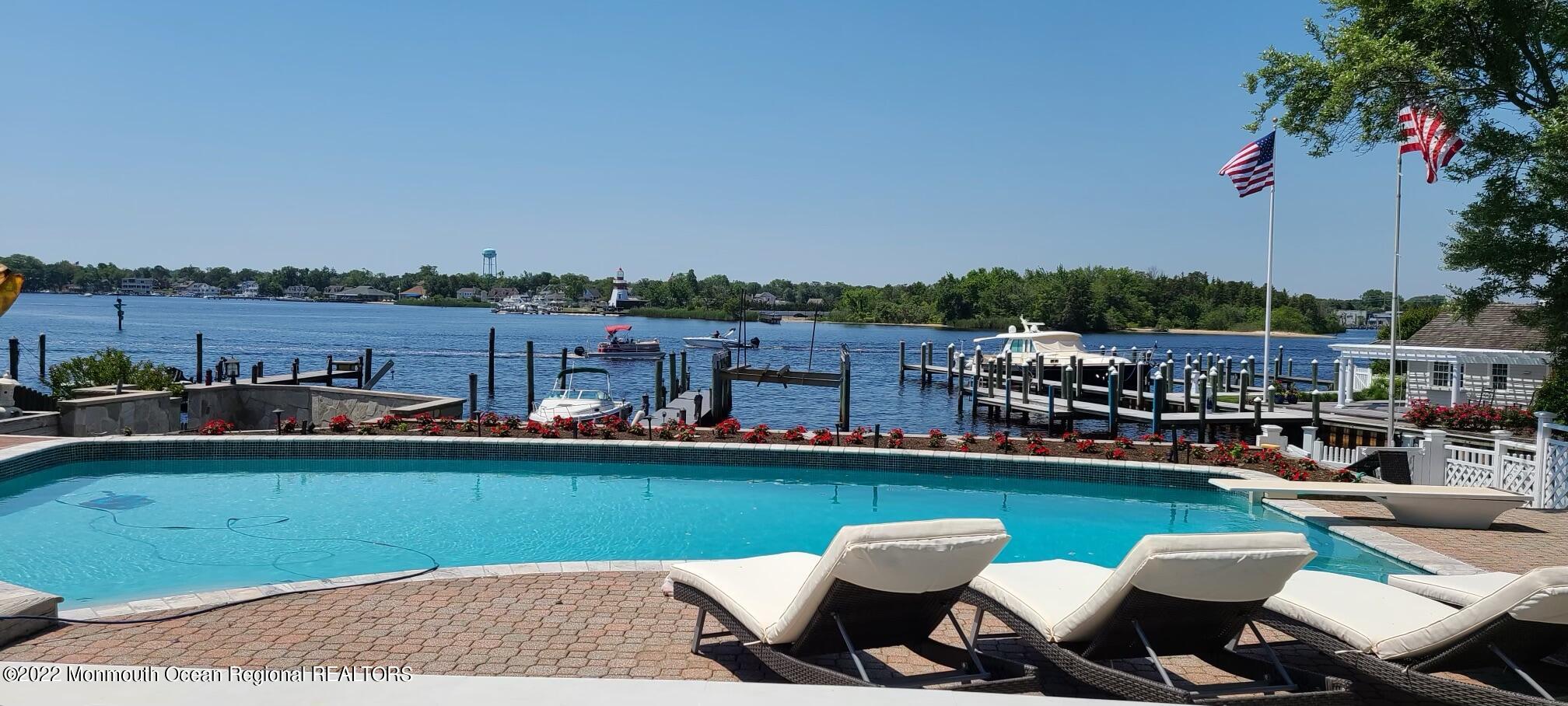 18 Brooks Road Toms River, NJ 08753 - Photo 52 of 53 a view of a lake with a table and chairs