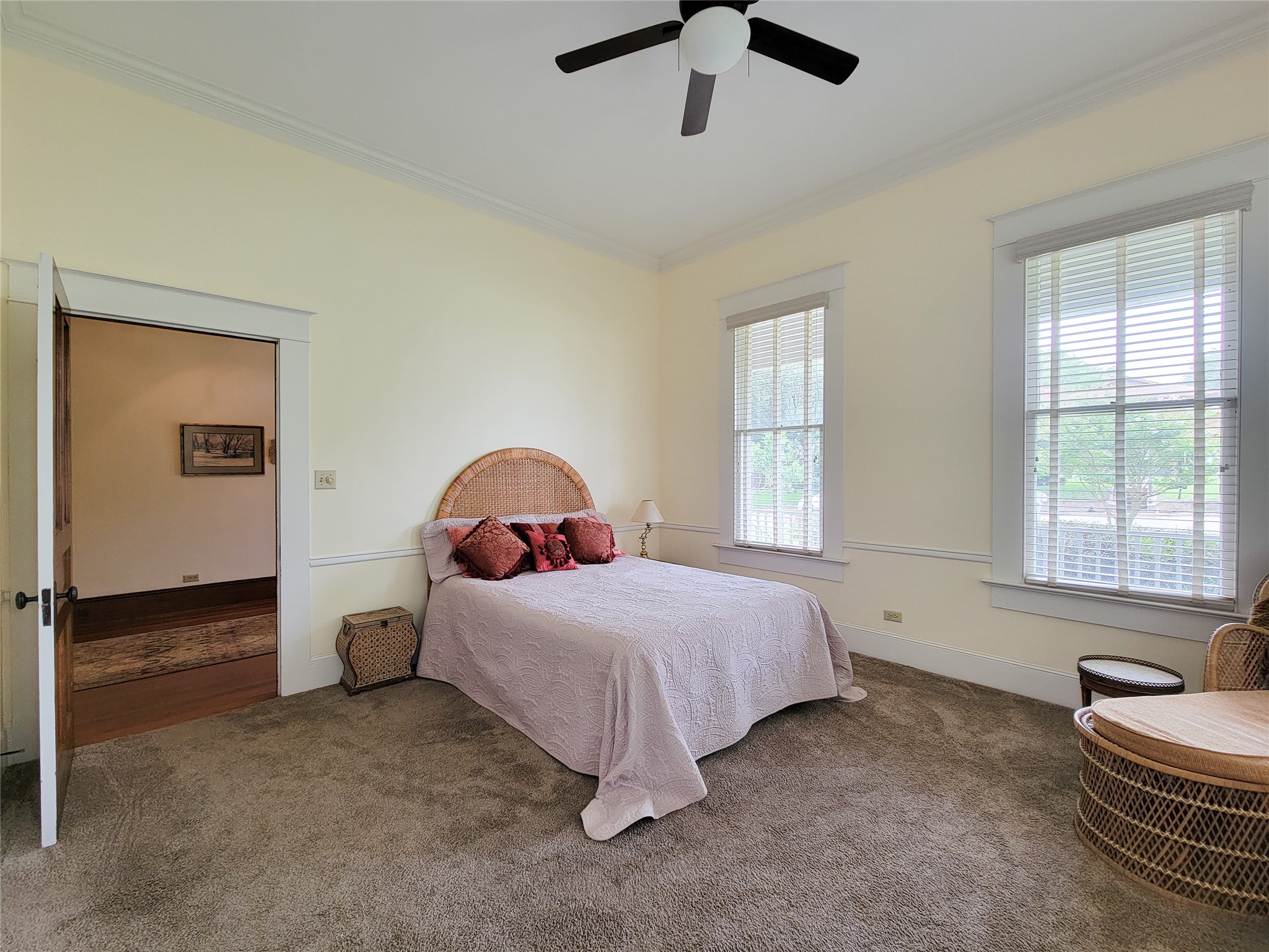 1406 Key Street Brenham, TX 77833 - Photo 17 of 50 Experience the main level primary retreat, featuring two spacious walk-in closets and abundant natural light from expansive windows.