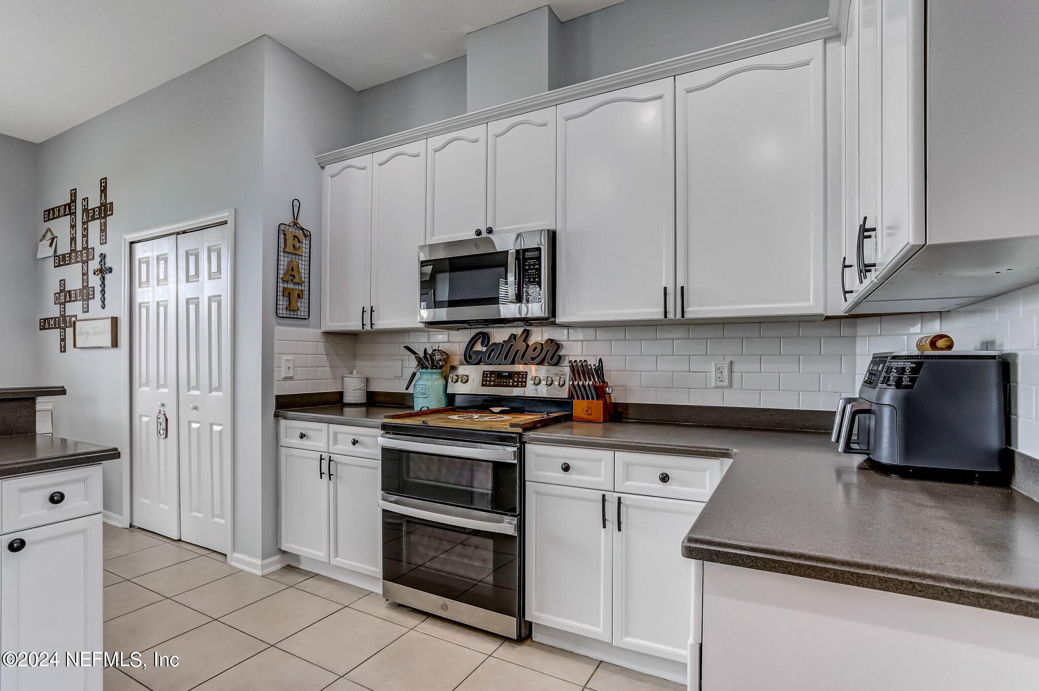 261 Porta Rosa Circle St. Augustine, FL 32092 - Photo 17 of 81 a kitchen with stainless steel appliances granite countertop a stove a sink and a refrigerator