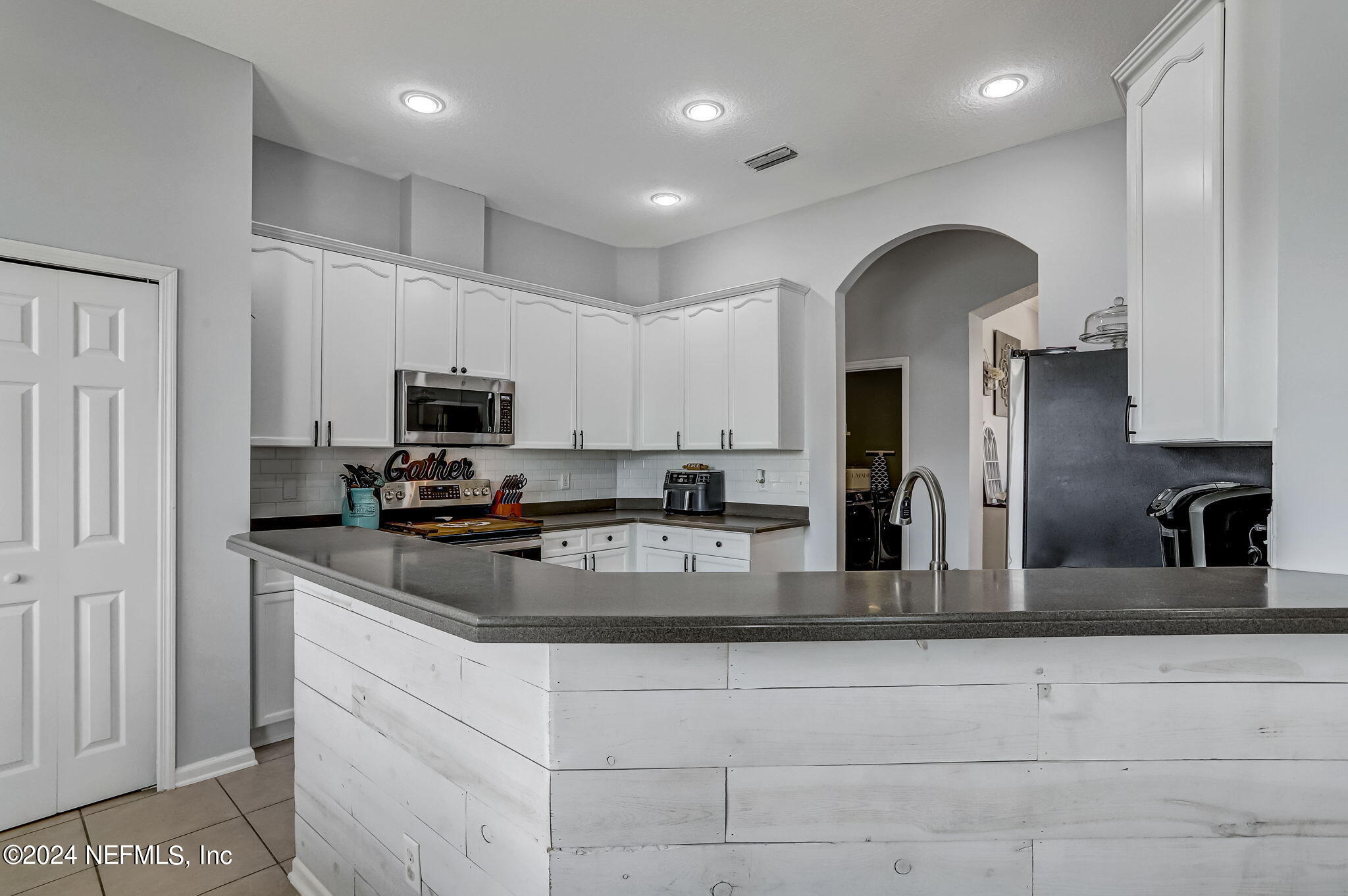 261 Porta Rosa Circle St. Augustine, FL 32092 - Photo 20 of 81 a kitchen with stainless steel appliances granite countertop a refrigerator and a sink