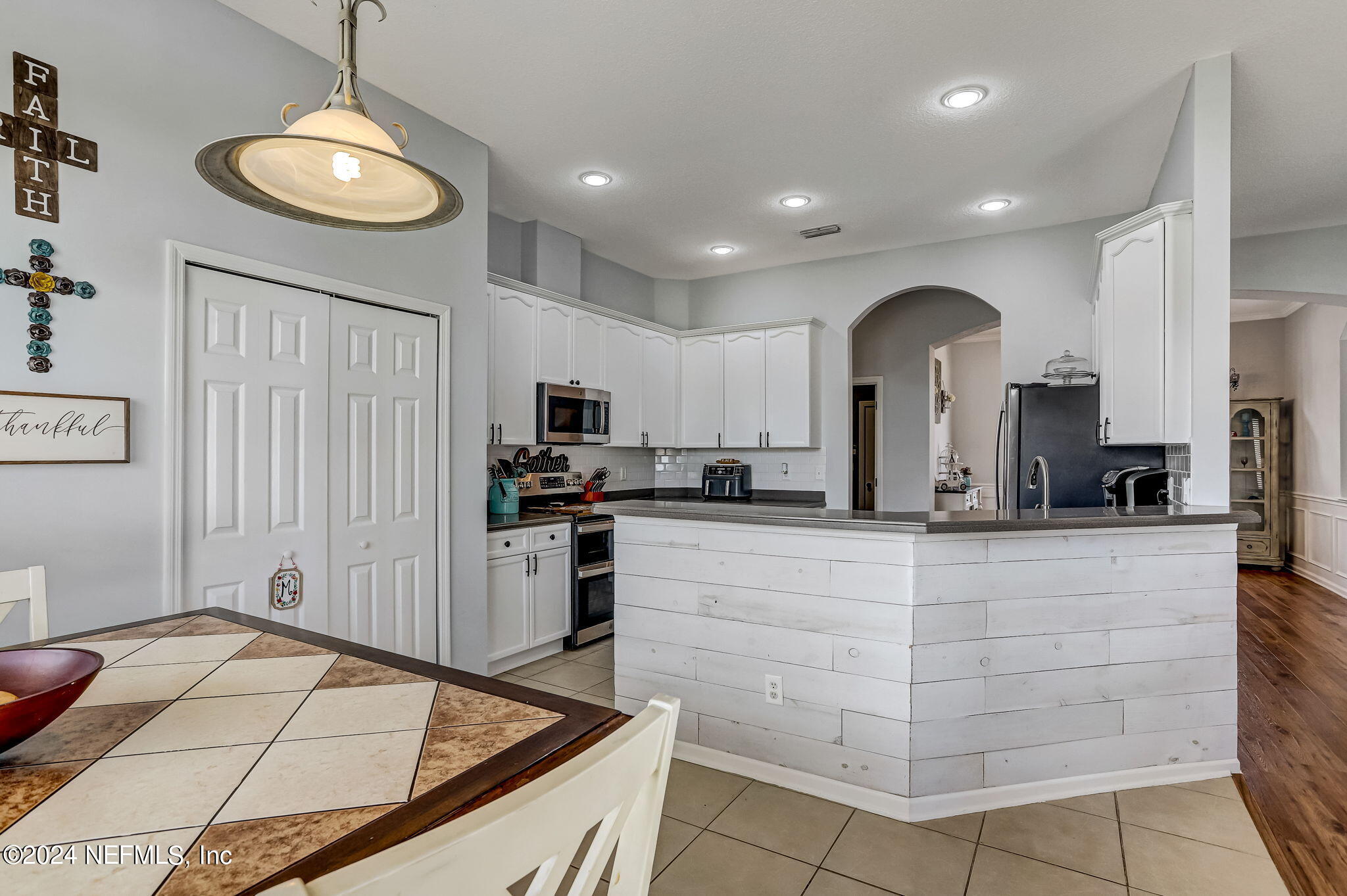 261 Porta Rosa Circle St. Augustine, FL 32092 - Photo 25 of 81 a kitchen with stainless steel appliances kitchen island granite countertop a refrigerator and a stove top oven