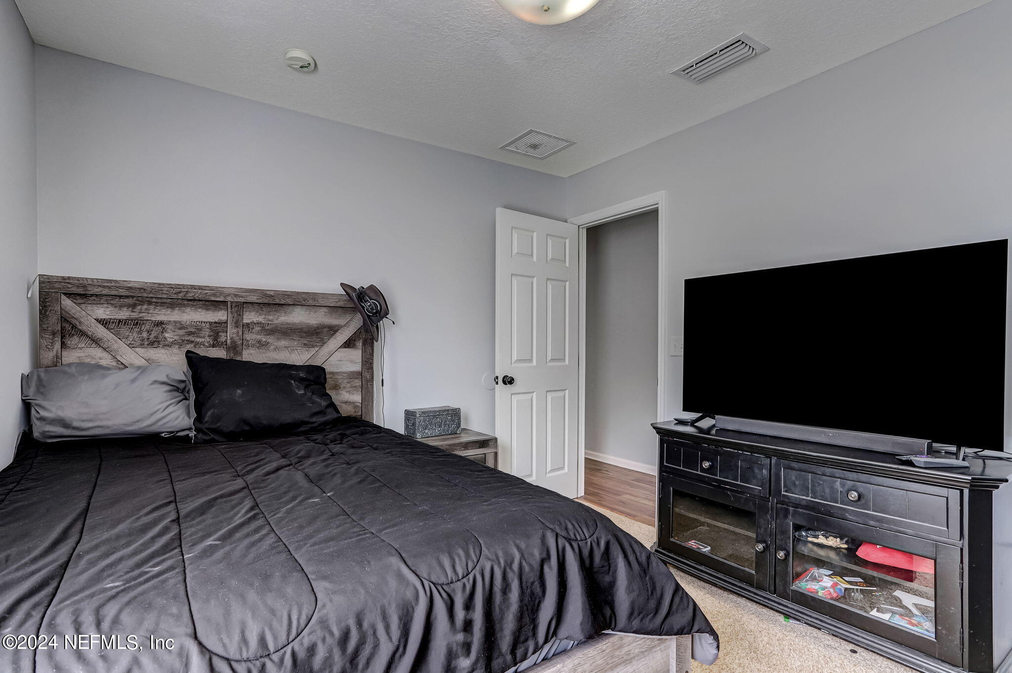 261 Porta Rosa Circle St. Augustine, FL 32092 - Photo 36 of 81 a bedroom with a bed and a flat screen tv