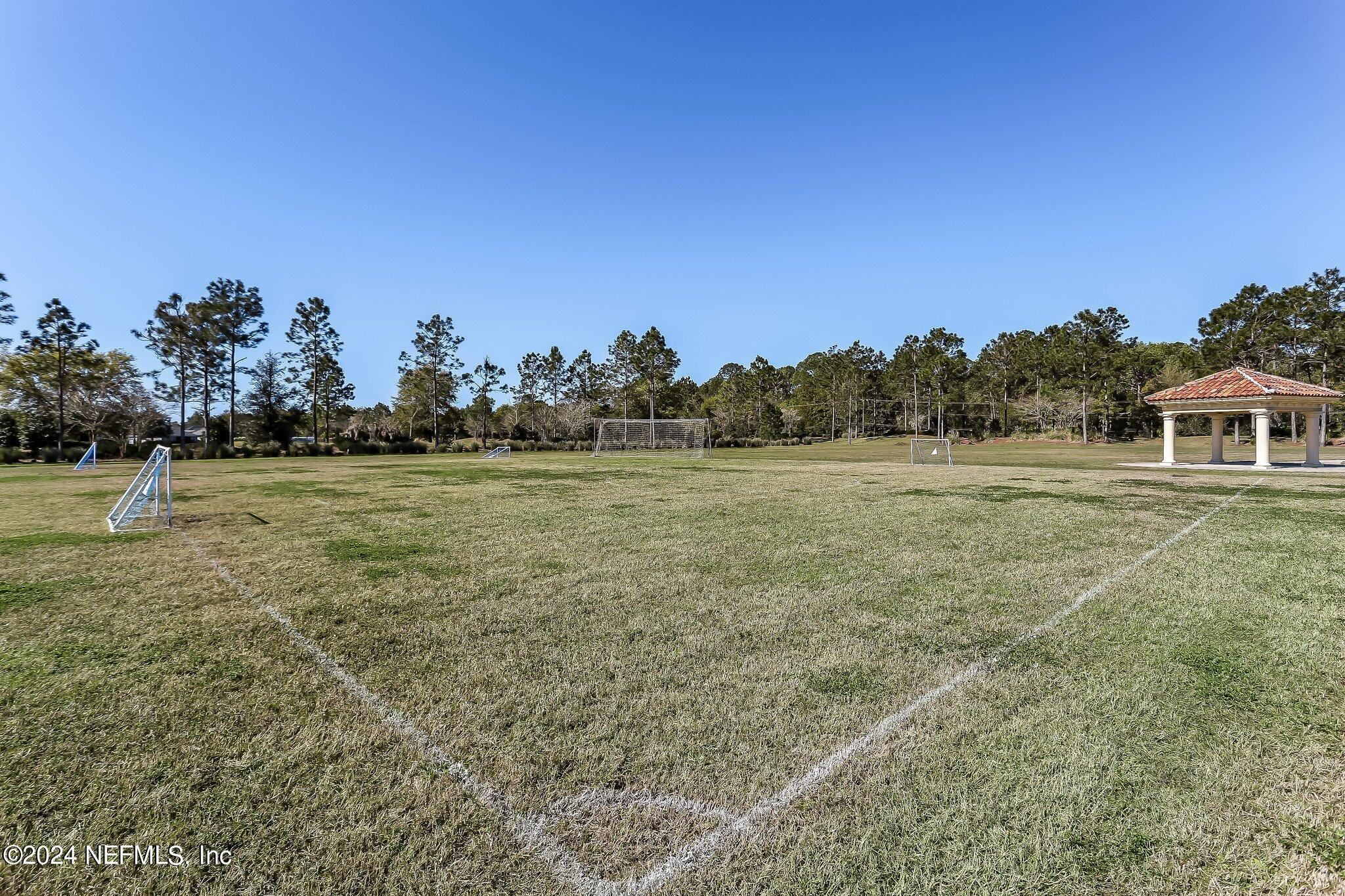 261 Porta Rosa Circle St. Augustine, FL 32092 - Photo 75 of 81 a view of a field with trees in the background