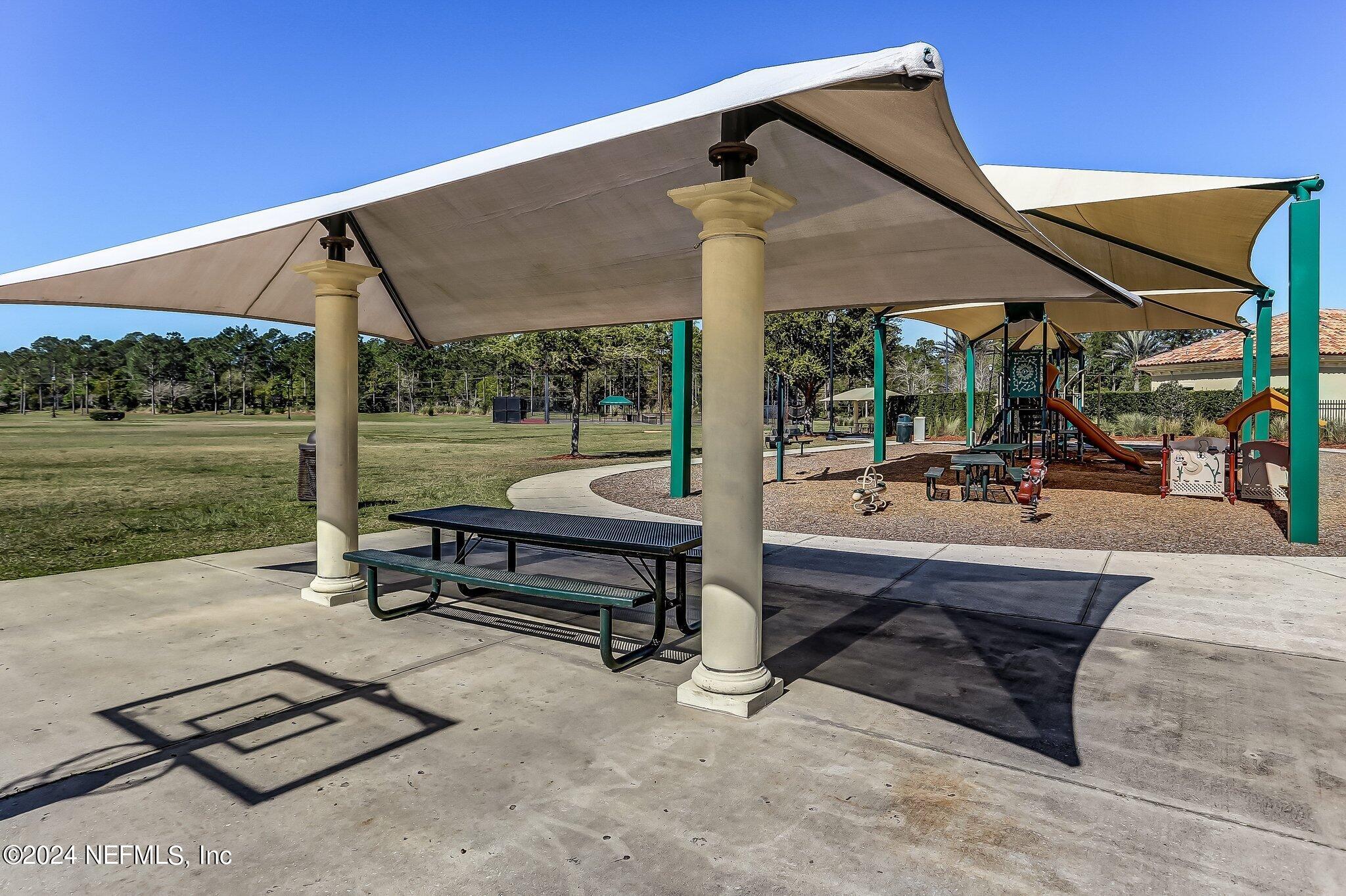 261 Porta Rosa Circle St. Augustine, FL 32092 - Photo 79 of 81 a backyard of a house with table and chairs
