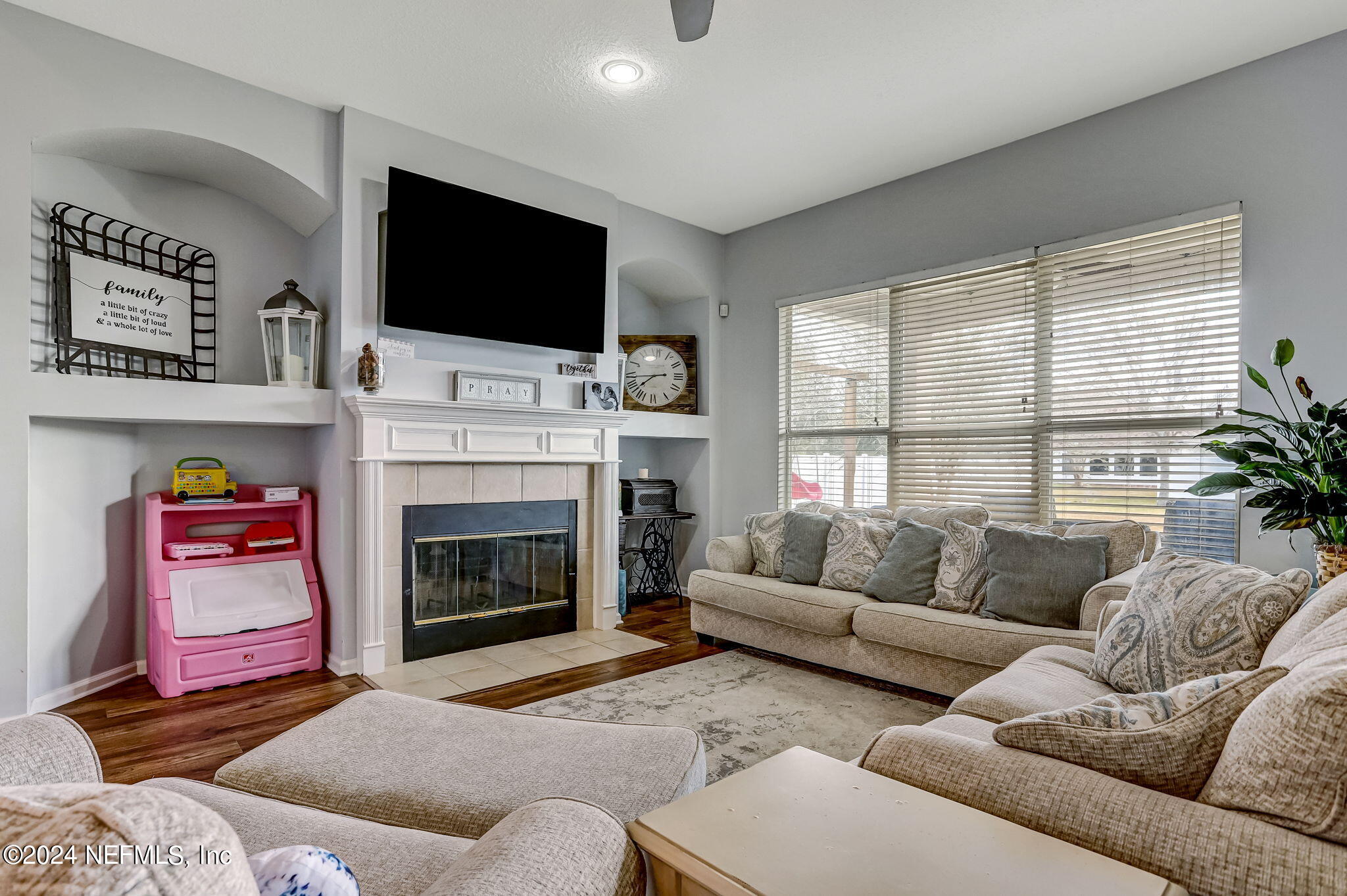 261 Porta Rosa Circle St. Augustine, FL 32092 - Photo 9 of 81 a living room with furniture a flat screen tv and a fireplace