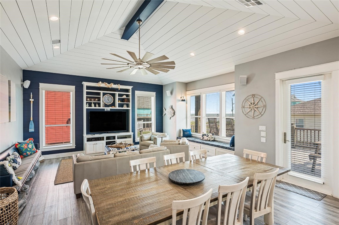 2576 Whitecap Crystal Beach, TX 77650 - Photo 14 of 49 a view of a dining room with furniture a chandelier and wooden floor