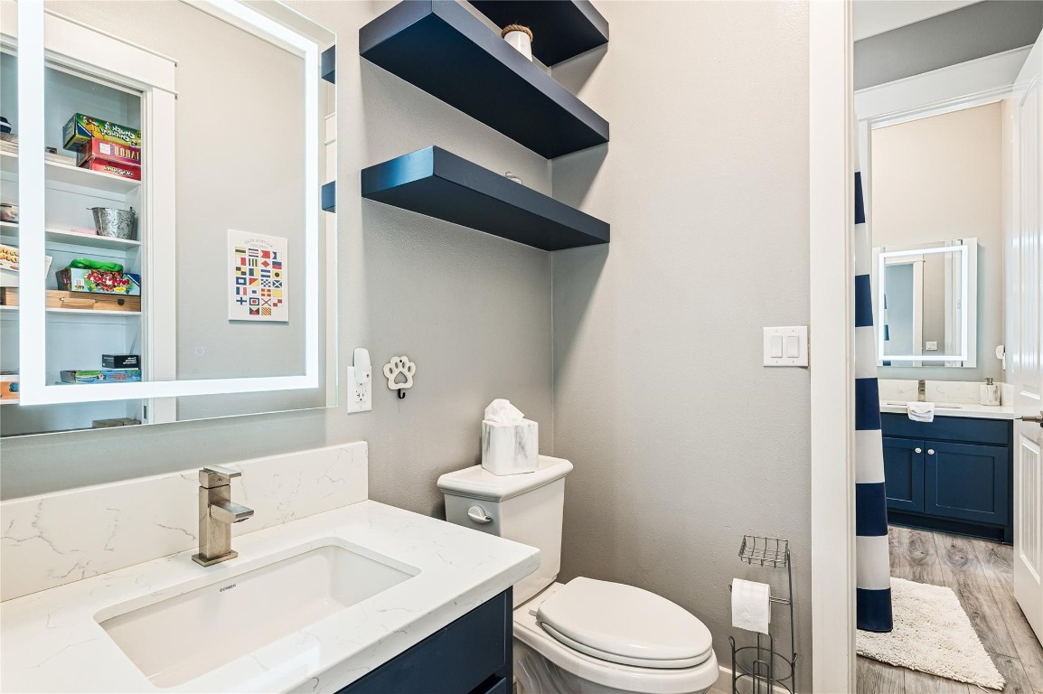 2576 Whitecap Crystal Beach, TX 77650 - Photo 35 of 49 a bathroom with a sink a toilet and a mirror