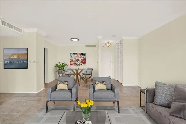 a living room with furniture and flowers