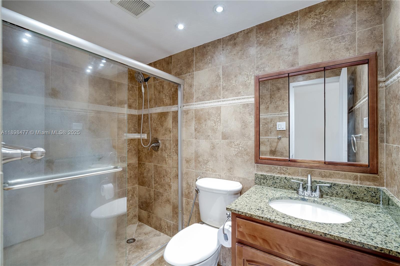 2451 Brickell Avenue, Unit 6N Miami, FL 33129 - Photo 25 of 43 a bathroom with a granite countertop sink toilet and shower